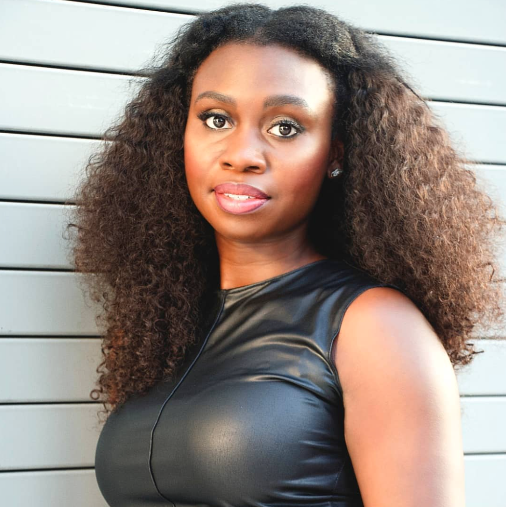 A woman with long hair wearing black leather.